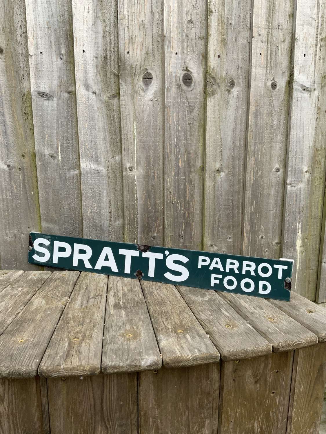 Light green spratts parrot food enamel advertising strip sign