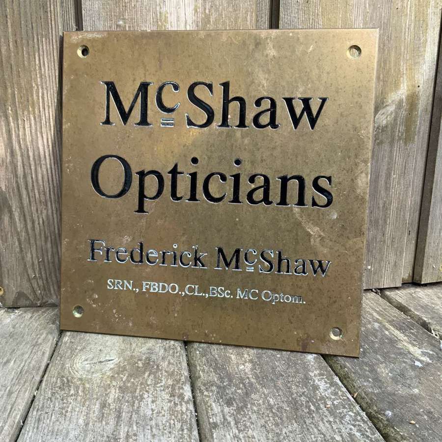 Small mc shaw opticians brass advertising sign