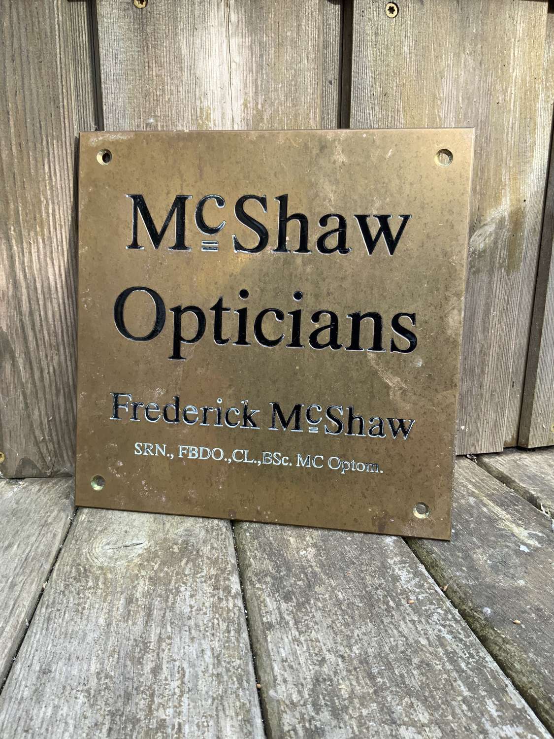 Small mc shaw opticians brass advertising sign